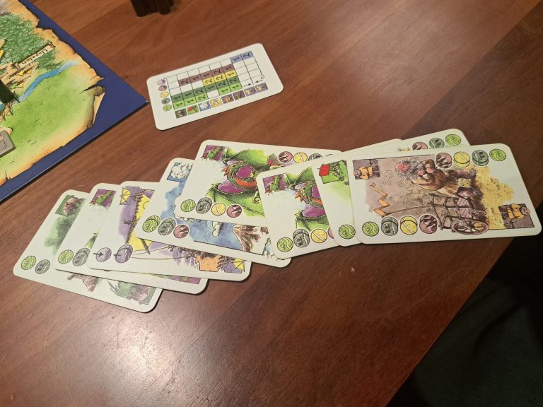 Brettspiel mit bunten Spielfiguren auf einem orangefarbenen Spielbrett.