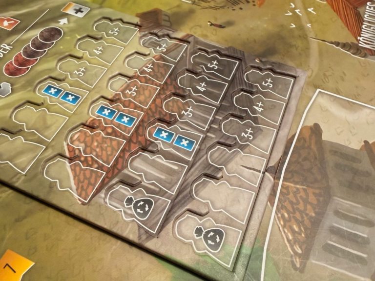 Spielbrett mit Ressourcen und Gebäuden, die strategisch angeordnet sind.